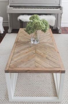 a coffee table with flowers in a vase on top