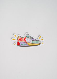 a sticker depicting a shoe with the words walk on it and an orange light