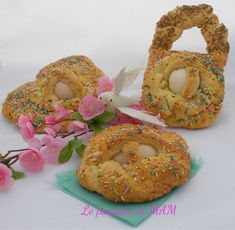 three pastries with sprinkles and eggs in them on a white surface