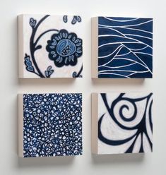 four square paintings with blue and white designs on them