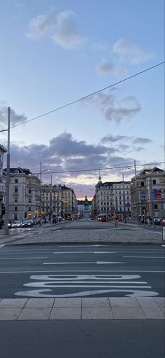 an empty city street with buildings in the background