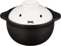 a black and white bowl with a cat face on the top is sitting in front of a white background