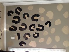 the wall is decorated with black and white polka dot decals, which appear to be question marks