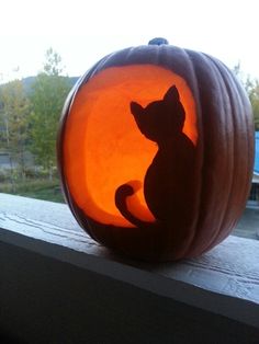 a carved pumpkin with a cat on it