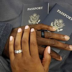 two people are holding their hands next to each other while wearing rings on their fingers