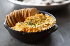 a black bowl filled with crackers on top of a table