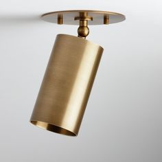 a gold colored light fixture hanging from the ceiling