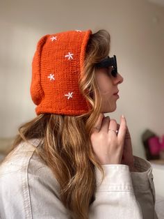 This handmade orange knitted tie bonnet for women is the perfect accessory to keep you warm and stylish during colder months. Its soft texture and adjustable tie closure ensure both comfort and a snug fit. Whether for everyday wear or as a unique gift, this elegant bonnet is a versatile addition to any wardrobe. *Hand-knitted orange tie bonnet for women *Soft and cozy for cold weather *Adjustable tie closure for a comfortable fit *Perfect for casual or outdoor winter wear *Thoughtful handmade gift for her Thank you for visiting Güneş Crafts! ☀️ In my small business you can find completely handmade dresses, bags, hats, skirts, sweaters, vests and decor items. I love the uniqueness of the sparkle of hand labour. All crochet items in my store are knitted with care. Each order is knitted indiv Orange Beanie For Winter, Winter Orange Hat, One Size Fits Most, Winter Orange Hat, One Size Orange Winter Hat, Orange Winter Hat, Orange Knitted Beanie Hat, Orange Crochet Hat For Winter, Winter Orange Adjustable Hat, Orange Crochet Hat, One Size