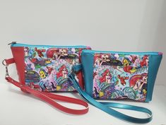 two purses with different designs on them, one is blue and the other has red