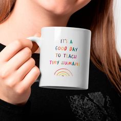 a woman holding a coffee mug with the words it's a good day to teach tiny humans