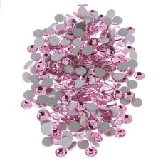 a pile of pink and silver buttons on a white background