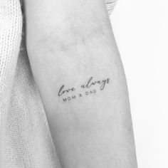 a woman's arm with the words, one always mom and dad written on it