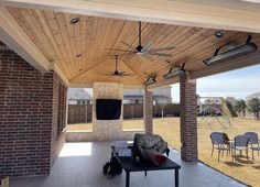 a covered patio with tables and chairs