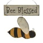 a wooden sign with a bee hanging from it's side that says, be blessed