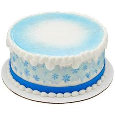 a blue and white frosted cake with snowflakes on it