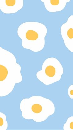 an image of fried eggs on a blue and white background that looks like they are floating in the air