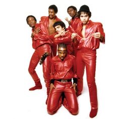 a group of men in red leather outfits