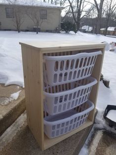 three baskets are stacked on top of each other outside in the snow