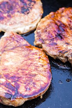 three hamburger patties cooking in a frying pan