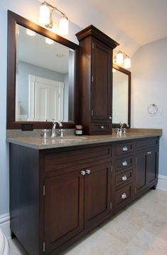 a bathroom with two sinks and large mirrors