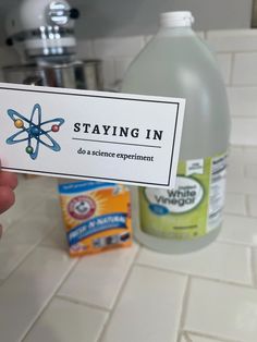 someone is holding up a business card that says staying in do a science experiment on it