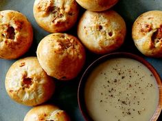 a plate full of bread rolls and a bowl of dipping sauce