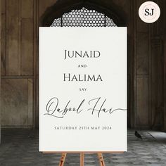 an easel with a sign in front of it that says, junaid and halima say dahab haq