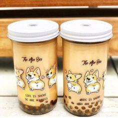 two glass jars filled with food sitting on top of a counter