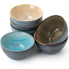 four bowls in different colors are stacked on top of each other