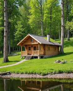 a log cabin sits on the bank of a lake in front of some trees and grass