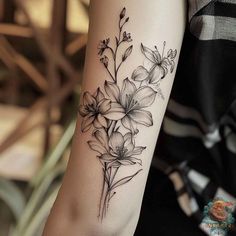 a black and white flower tattoo on the arm