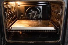 an oven with the door open and it's light on, revealing something inside