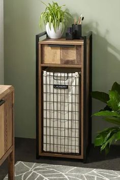 a wooden cabinet with a plant on top and an airplug in the corner