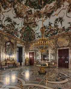 an ornately decorated room with chandeliers and mirrors