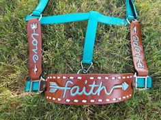 a brown leather harness with the word faith written on it and an arrow at the bottom