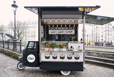 an ice cream cart is parked on the street