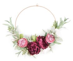 a floral wreath with pink and red flowers