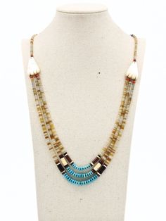 DESCRIPTION: This vintage Native American piece, skillfully crafted by a Navajo artist in the 1950s, epitomizes the artistry and tradition of its culture. Comprising a triple-strand necklace crafted from delicate shell heishi beads, its centerpiece features captivating turquoise disc beads, accentuated by rich brown barrel beads that enhance its prominence. Adding to its allure, Mother of Pearl accents adorn each side of the necklace, securing the three strands in place with elegance. Fastened w Traditional Multi-strand Turquoise Beaded Necklace, Traditional Turquoise Multi-stone Necklace, Luxury Southwestern Hand-strung Beaded Necklaces, Blue Southwestern Hand-strung Necklaces, Silver Southwestern Multi-stone Turquoise Necklace, Necklace Craft, Heishi Beads, Strand Necklace, Chain Styles