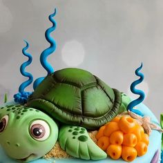 a cake with a turtle and carrots on it