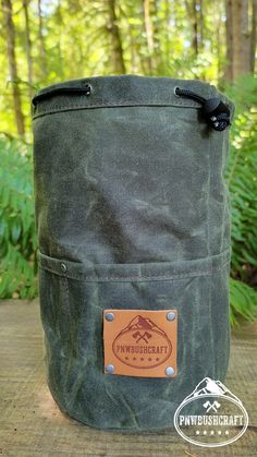 Handcrafted Waxed Canvas Bucket Bag with Outside Pockets Do you enjoy keeping things organized? Wouldn't it be awesome to have a waxed canvas bag that contains everything you need for cooking in the woods? Want to pass down your gear to the next generation? Then take a look at this high-quality Cedar Waxed Canvas Bucket Bag with Outside Pockets, complete with a hand-branded leather tag, handcrafted right here in our Washington shop by our family. Made of durable 10.1 oz waxed canvas, this bucket Waxed Canvas Bags For Camping, Canvas Bucket Bag, Waxed Canvas Bag, Leather Tag, Canvas Pouch, Waxed Canvas, The Next Generation, Diy Canvas, Next Generation