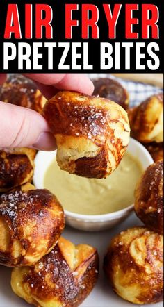 a person dipping some kind of pretzel bites into a small bowl with sauce