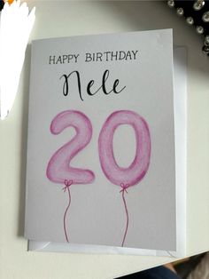 a birthday card with the number 20 on it and balloons in the shape of numbers