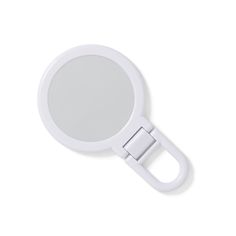 a magnifying glass on a white surface with clippings for eyeglasses