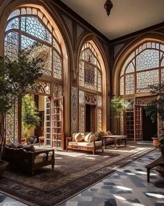 an ornately decorated living room with lots of windows and large rugs on the floor