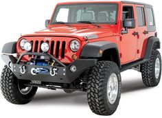 a red jeep is parked in front of a sign that says light weight aluminum construction