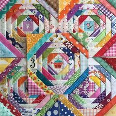 a colorful quilt with many different patterns on it