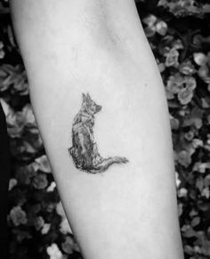 a small cat tattoo on the left arm