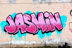 graffiti on the side of a building that says jasmin in pink and blue