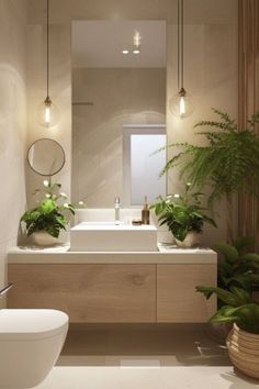 a bathroom with two plants and a toilet