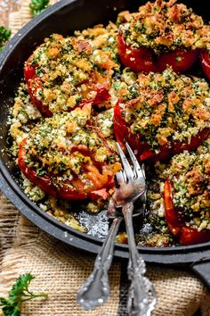 a skillet filled with tomatoes covered in parmesan cheese and seasoning sprinkles